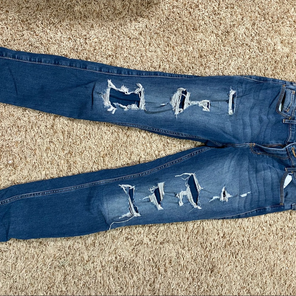 Mid rise skinny jeans with patched rips
